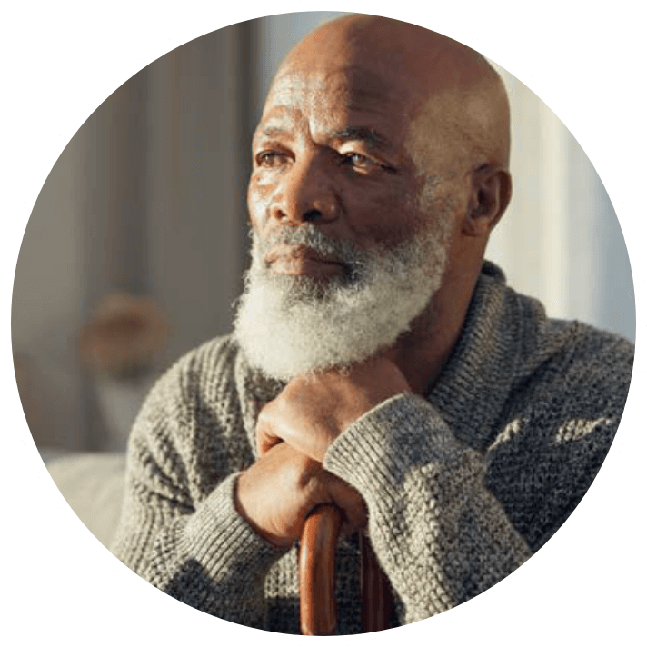 Older man in room thinking