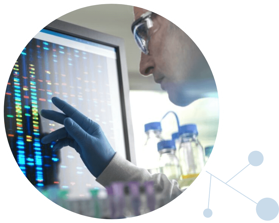 Scientist looking at monitor with DNA data on it